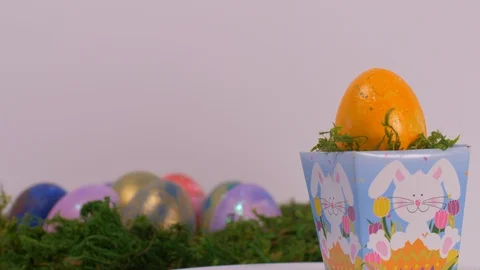 Yellow Egg Rotating on Easter Basket. Easter Stock-Footage 129213582