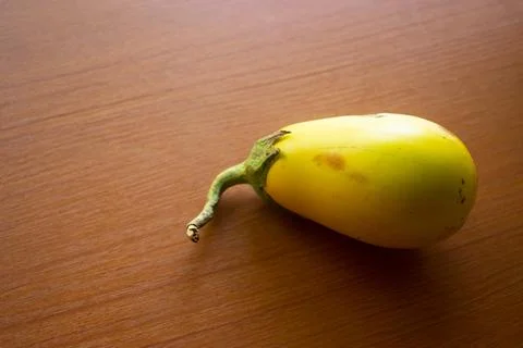 The yellow eggplant placed on the table is brown Stock Photos