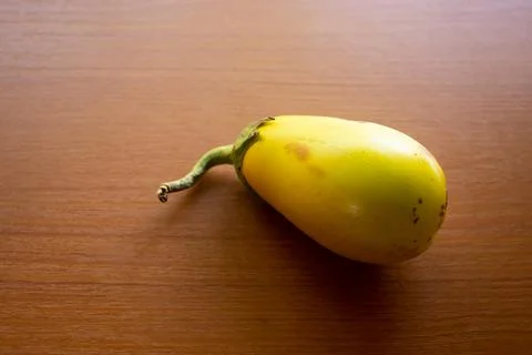 The yellow eggplant placed on the table is brown Stock Photos