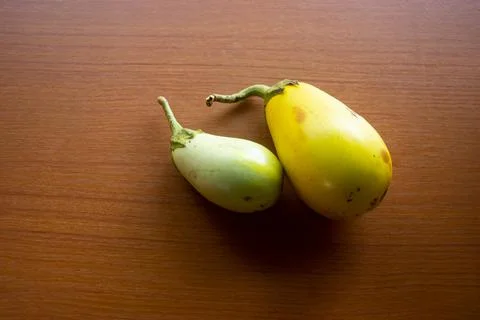 The yellow eggplant placed on the table is brown Stock Photos