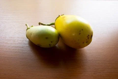 The yellow eggplant placed on the table is brown Stock Photos