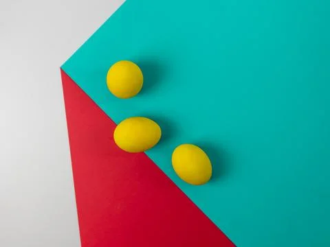 Yellow eggs on a cube, easter eggs, optical illusion of a paper cube, copy sp Stock Photos