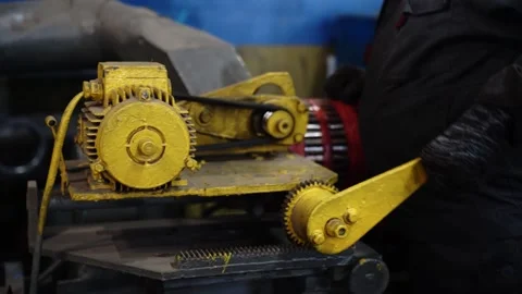 Yellow electric motor and gear mechanism in metal workshop Stock-Footage 348029853