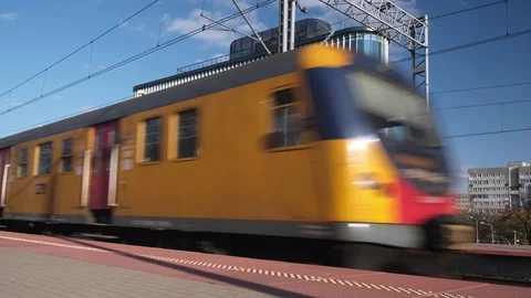 Yellow electric train arrives on empty platform of railway station Stock Footage 124846371