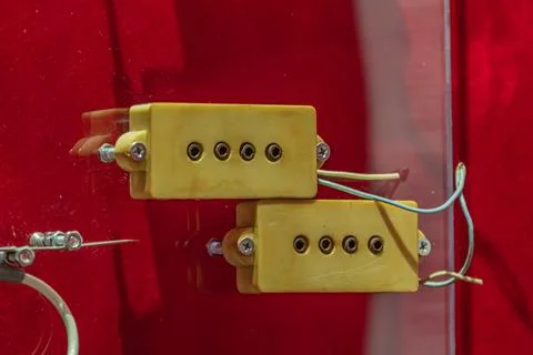 Yellow Electrical Component with Wires and Screws on Red Background 写真素材