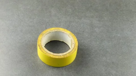 Yellow electrical tape on gray Stock Footage 205003588