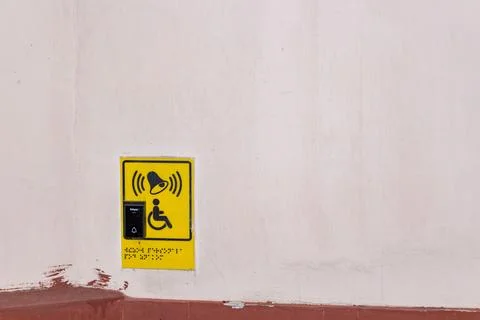 Yellow emergency call button for disabled people on the white wall Stock Photos