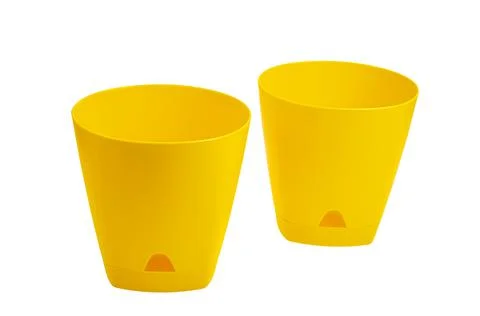 Yellow empty plastic flower pots isolated on white background Stock Photos