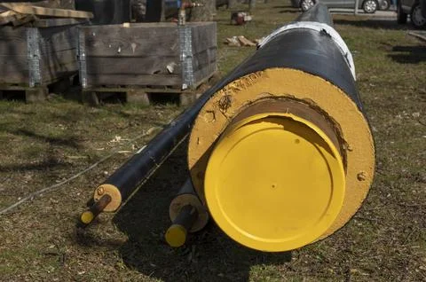 The yellow end of a district heating pipe lying on the ground Stock Photos