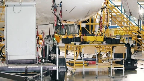 Yellow engineering ladders near the Boeing 737 aircraft embraer Stock Footage 102617902