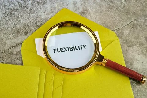 A yellow envelope rests on a surface. A magnifying glass highlights the word  Stock Photos