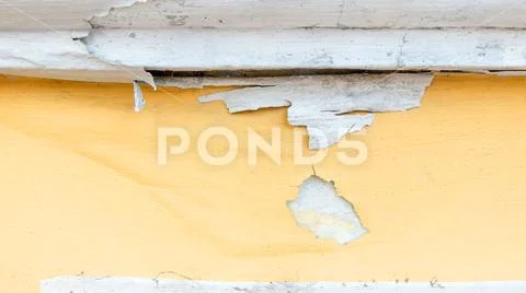 Yellow erode painted concrete wall,grunge rough texture background Stock Photos