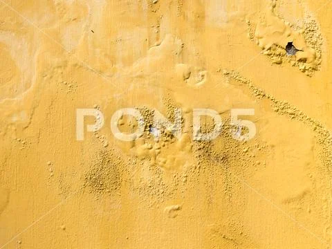 Yellow erode painted concrete wall,grunge rough texture background Stock Photos