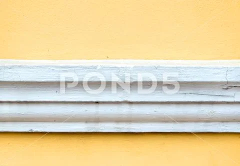 Yellow erode painted concrete wall,grunge rough texture background. Stock Photos