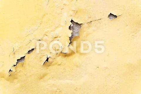 Yellow erode painted concrete wall,grunge rough texture background. Stock Photos