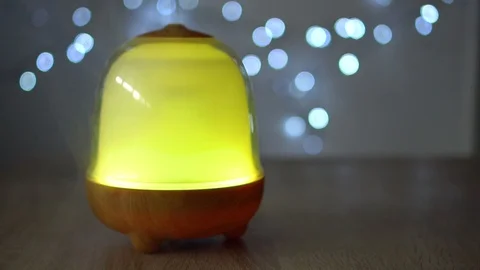 Yellow essential oil diffuser that gives off a smoke, on a bright Stock Footage 107131438