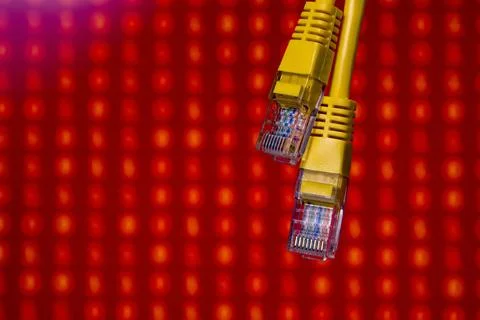 Yellow ethernet cables on red digital background Foto stock