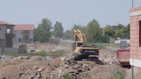 Yellow Excavator Digging Through Rubble on Construction Site Stock-Footage 347929316