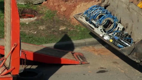Yellow excavator loader bucket with drilling equipment on asphalt, close-up Stock-Footage 318289844