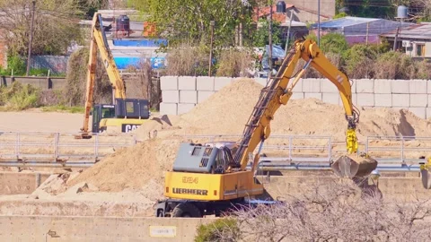 Yellow excavator machine working at a construction site Stock Footage 345938806