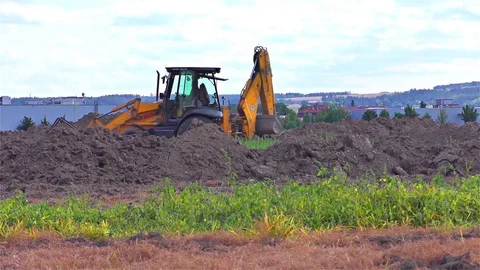 Yellow excavator - tractor on a working platform Stock Footage 79984133