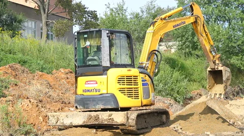 Yellow excavator working on a construction site Stock Footage 67340657