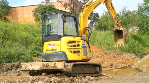 Yellow excavator working on a construction site Stock Footage 67340679