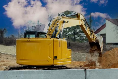 Yellow excavator on a working platform Stock Photos