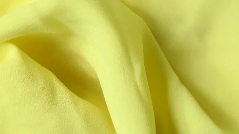 Yellow fabric background rotates on a board Stock Footage 247247831