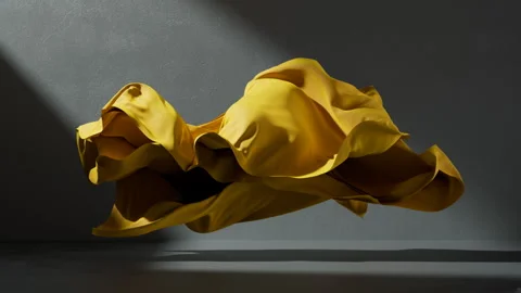Yellow fabric flutters chaotically inside the concrete room Stock Footage 322134873