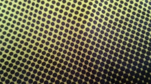 Yellow fabric texture featuring dark polka dot pattern motion footage Stock Footage 341770815