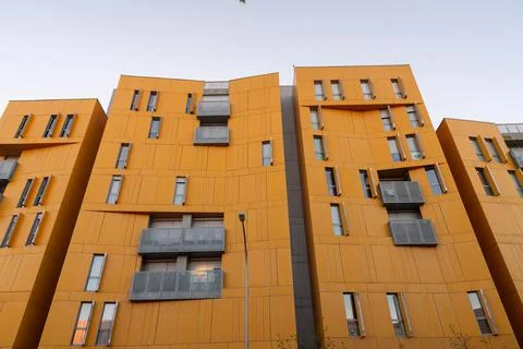 Yellow facade of a building from below Stock Photos