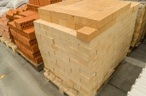 Yellow facing brick on a pallet. Bricks in a construction material store Stock Photos