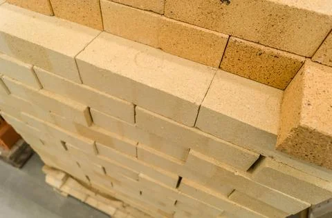 Yellow facing brick on a pallet. Bricks in a construction material store Stock Photos