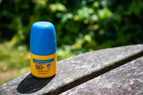 Yellow factor 50+ roll-on sunscreen with blue lid Stock-Fotos