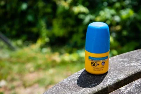 Yellow factor 50+ roll-on sunscreen with blue lid Stock Photos