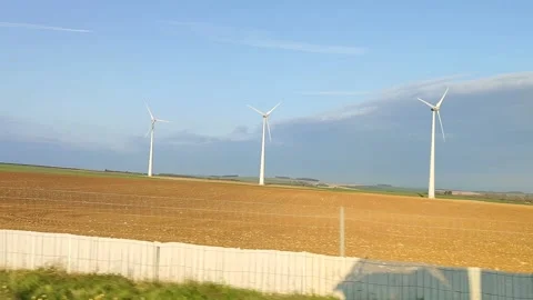 Yellow fields with windmills and shadow of a passing truck Stock Footage 152615349