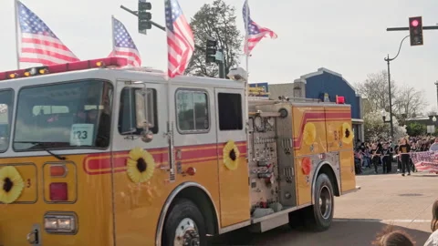Yellow fire engine decorated with flowers carrying American flags  sammer egg 55 Stock Footage 340169771