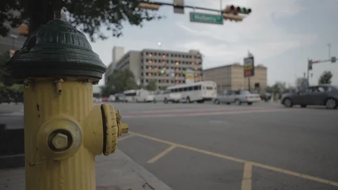 Yellow Fire Hydrant On Sidewalk Beside Busy Street With Traffic Stock Footage 100850929