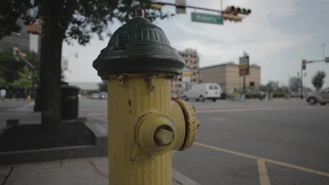 Yellow Fire Hydrant On Sidewalk Beside Busy Street With Traffic Stock Footage 100851149