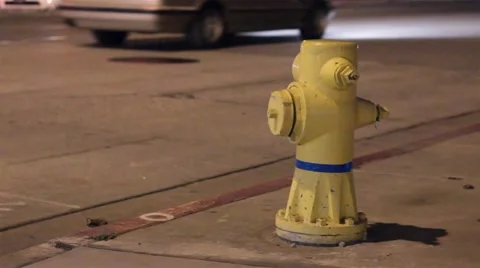 Yellow fire hydron at night at busy intersection Stock Footage 47466556