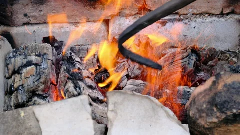 Yellow Fire with Red Coals on a Brick Background. Video stock 133121004