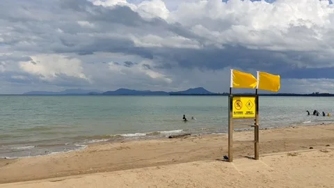 Yellow Flag On The Beach Stock Footage 143127260