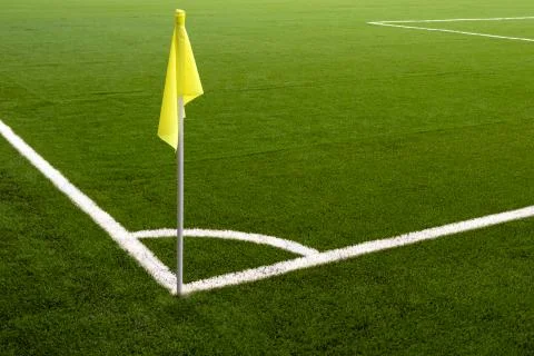 Yellow flag on the corner of a football field. White line marking sports fiel Stock Photos