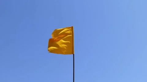 Yellow flag on the sea. warning the danger at sea flag in the wind Stock Footage