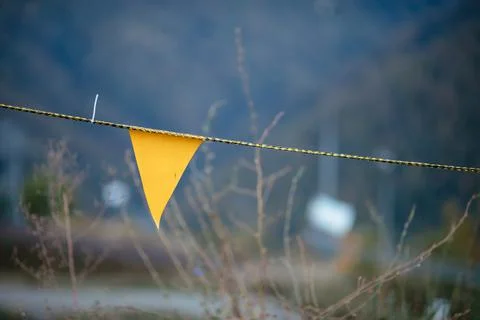 Yellow flag for warning on the road Stock Photos