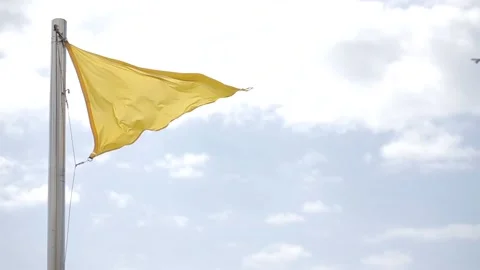 Yellow flag wawing on the wind. Stock Footage 146816354