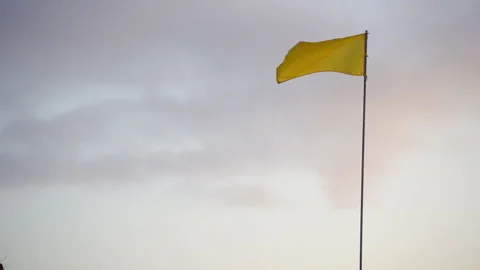 Yellow Flag In Wind At Sunrise Stock Footage 146102853