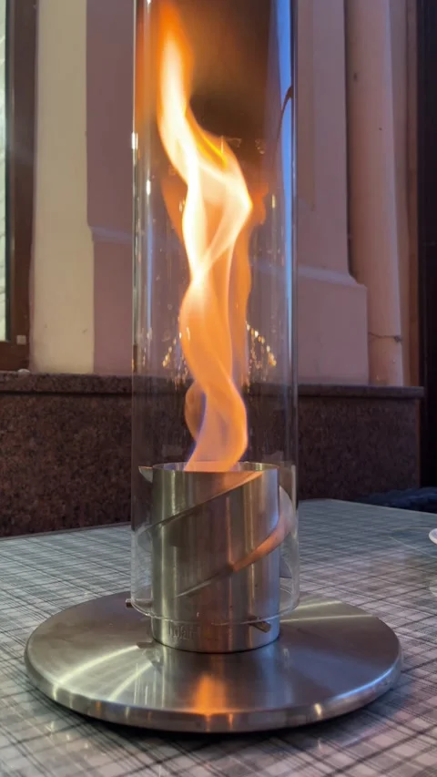 Yellow flames flickering inside a glass lamp Stock Footage 329319853