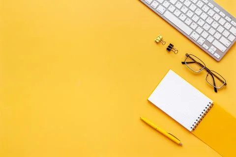 Yellow flat lay top view office table desk with keyboard and office supplies Stock Photos